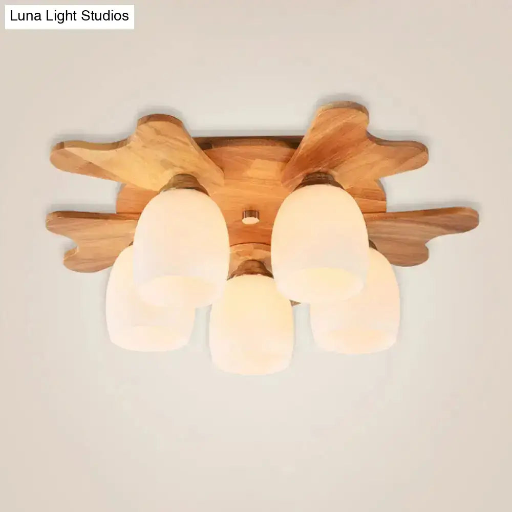 Nordic cream glass bell ceiling light with wood antler featuring five frosted cream glass shades in leaf pattern