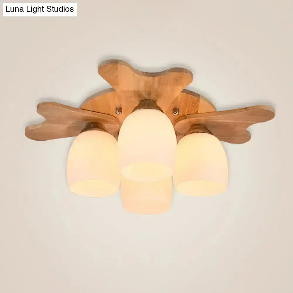 Nordic cream glass bell ceiling light with wooden leaf-shaped arms and three frosted glass shades for bedroom use