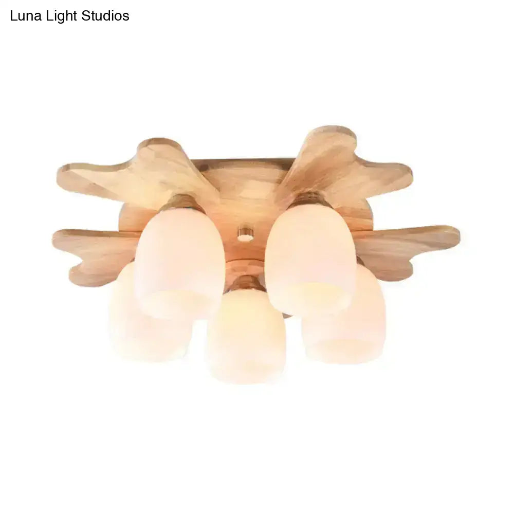 Nordic ceiling light with wood antler base and five cream glass bell frosted shades for bedroom lighting