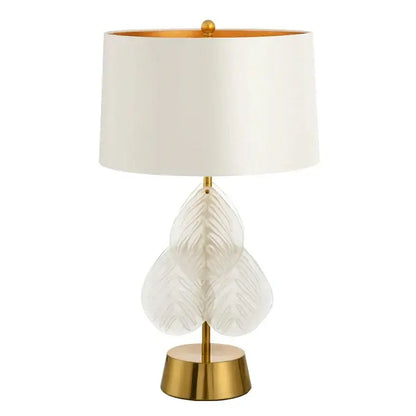Elegant white leaf-shaped crystal table lamp with gold-toned brass base and trim for bedroom use