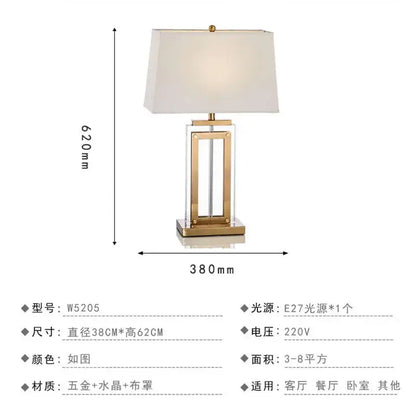 Gold-toned nordic crystal table lamp with rectangular crystal base and cream fabric shade for bedroom use