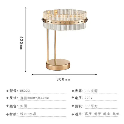 Nordic crystal table lamp with gold-toned metal base and circular clear crystal prisms for bedroom use