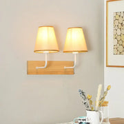 Nordic flaxen and wood bedroom wall sconce with warm-toned fabric lampshades and white metal arms featuring led incandescent