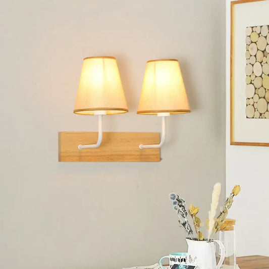 Nordic flaxen and wood bedroom wall sconce with warm-toned fabric lampshades and white metal arms featuring led incandescent