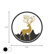 Circular wall decal featuring a gold deer with antlers adorned with birds, set against black mountain silhouettes within a white circle framed by a thick black border.