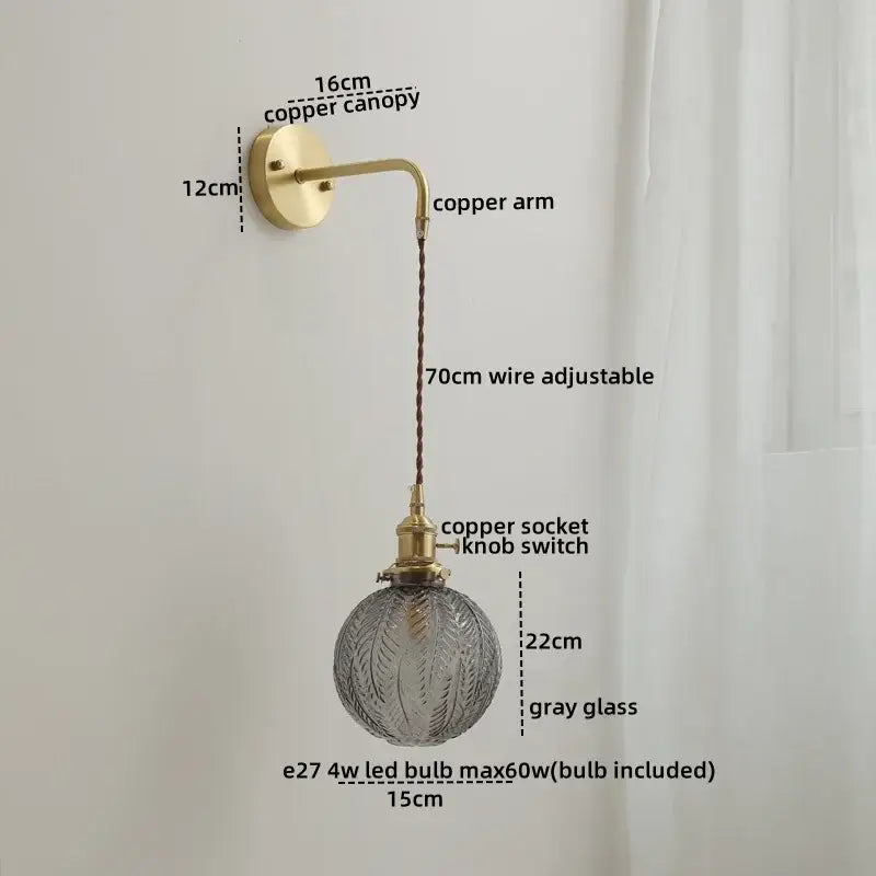 Nordic wall sconce lamp with brass copper arm and textured gray glass globe suspended by adjustable braided cord