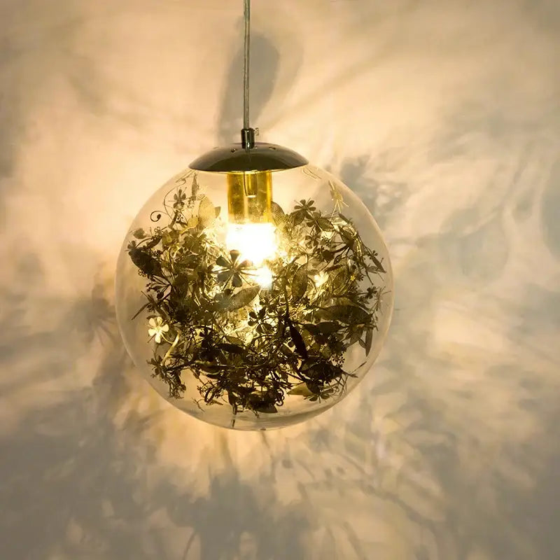 Nordic gold floral glass led pendant lamp with dried green and brown foliage and warm glow for kitchen lighting