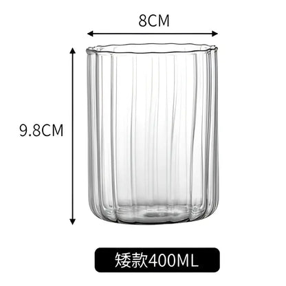 Clear glass ripple cup with vertical ribbed texture and gold leaf spoon for dining room use in nordic style
