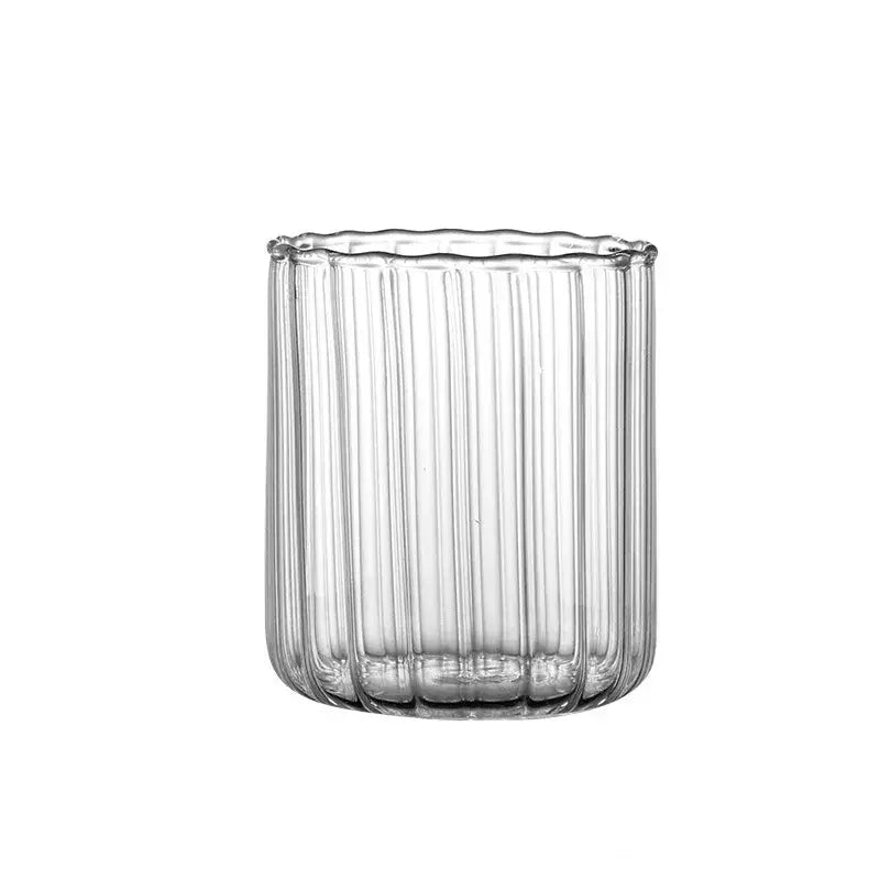 Clear glass ripple cup with vertical ribbed texture and scalloped rim for nordic heat resistant dining use