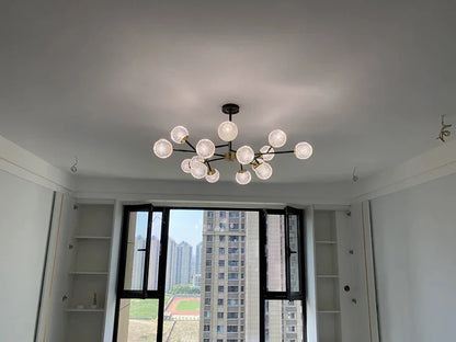 Modern chandelier with multiple spherical glass bulbs and dark metal frame for nordic dining room lighting