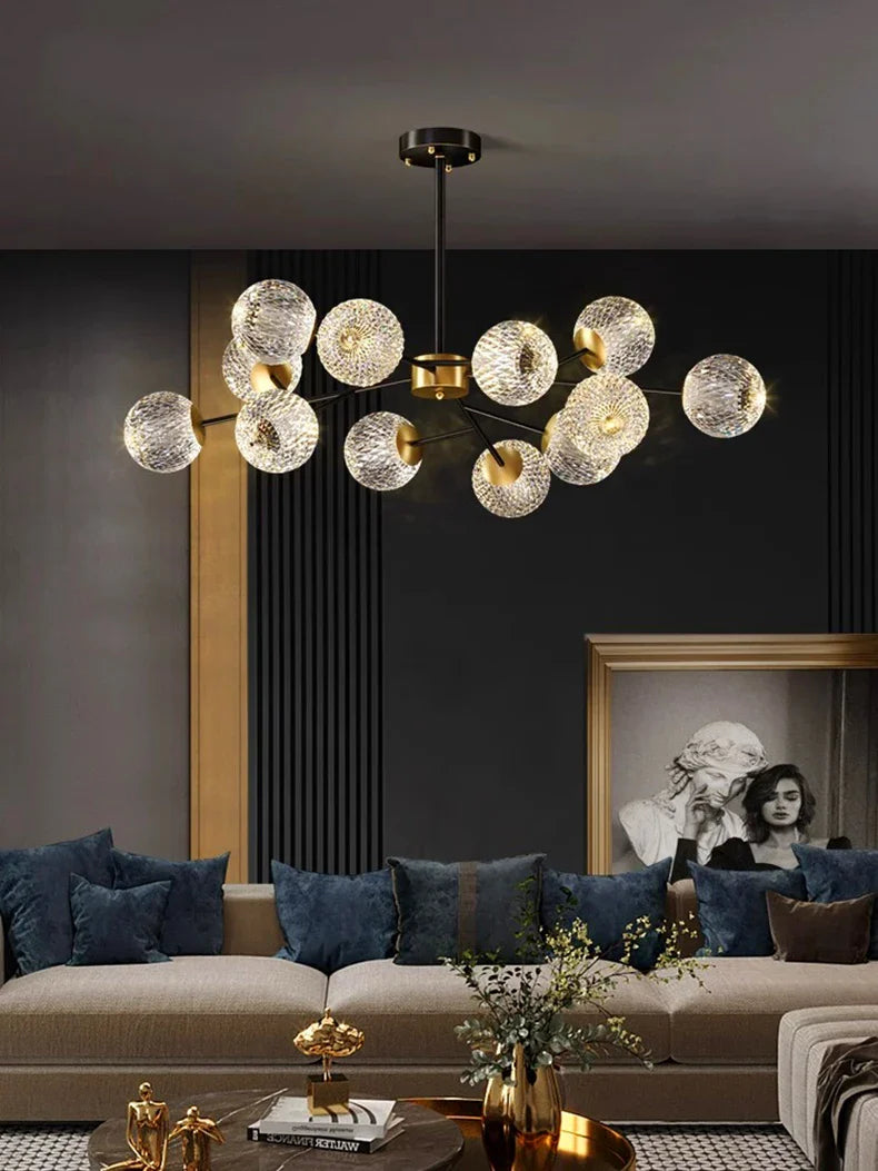 Gold-toned Nordic pendant chandelier with textured glass spheres suspended from a brass fixture for indoor dining room lighting