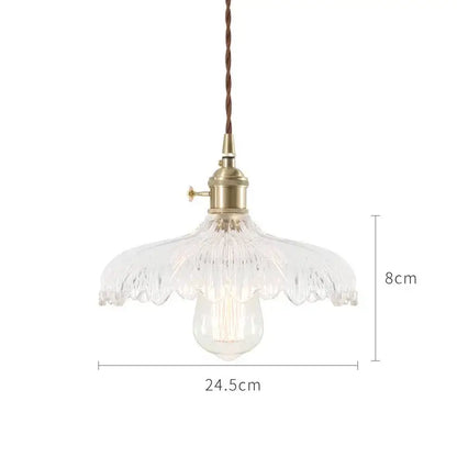 A clear glass pendant light with fluted petal shade and brass hardware in nordic japan style for dining room pendant lights
