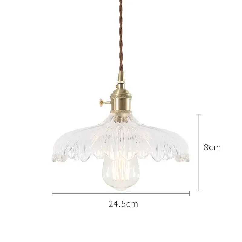 A clear glass pendant light with fluted petal shade and brass hardware in nordic japan style for dining room pendant lights