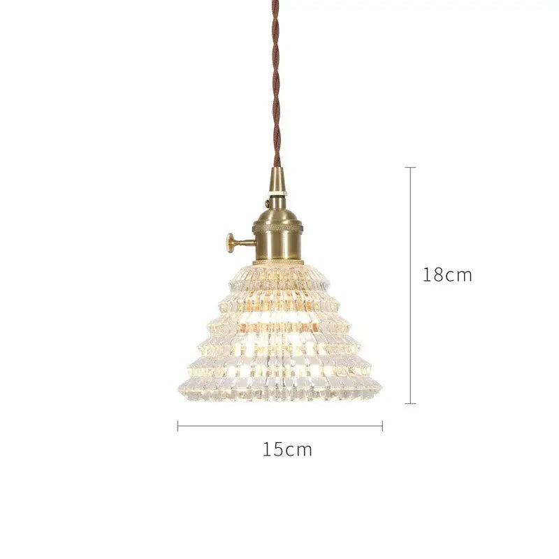 A nordic japan style glass pendant light with tiered crystal design, brass base, and twisted brown cord, 18cm height