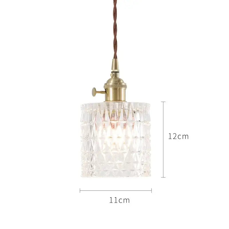 Clear faceted glass pendant lights with brass fixture and twisted brown cord in nordic japan style for dining room