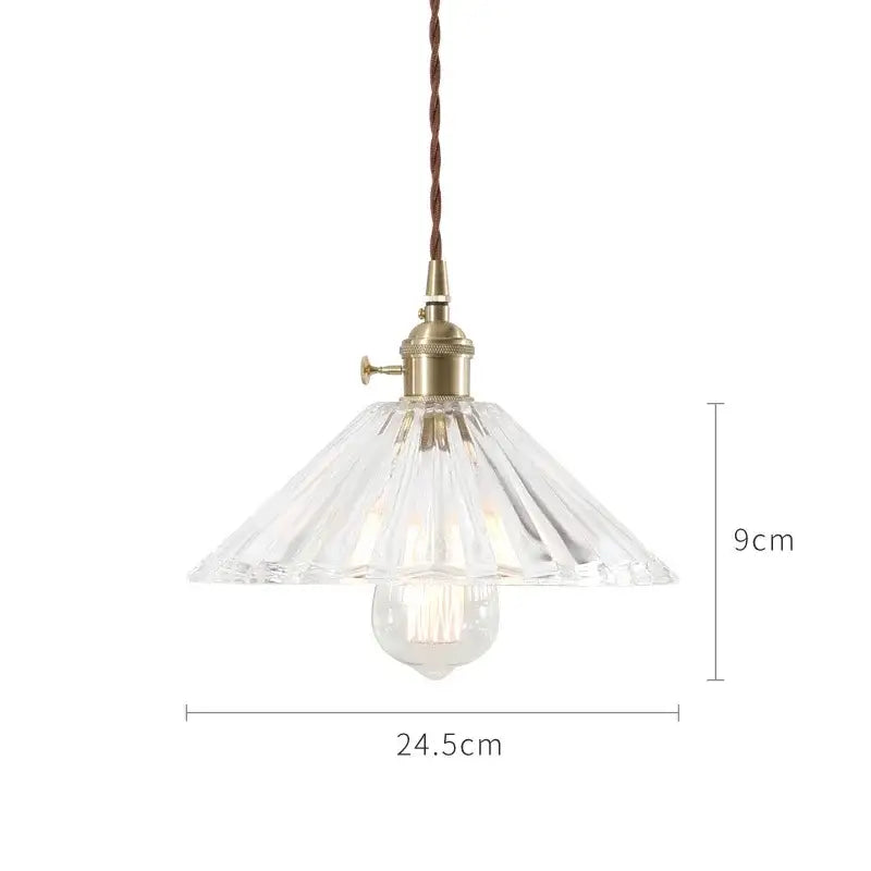 A nordic japan style glass pendant light with clear faceted glass, brass fixture, and twisted brown cord for dining room