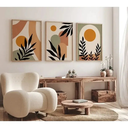 Cream-colored plush armchair with rounded contours and textured fabric next to decorbites™ abstract nordic leaf canvas wall art