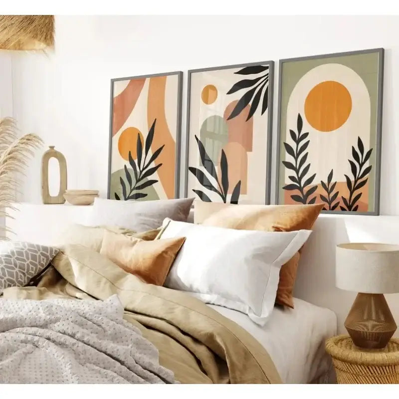 Three framed abstract wall art prints with black leaf silhouettes and warm orange beige and muted green shapes by decorbites