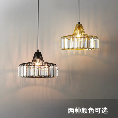 Two nordic LED crystal pendant lamps with black and gold iron frames and clear crystal panels for kitchen island lighting