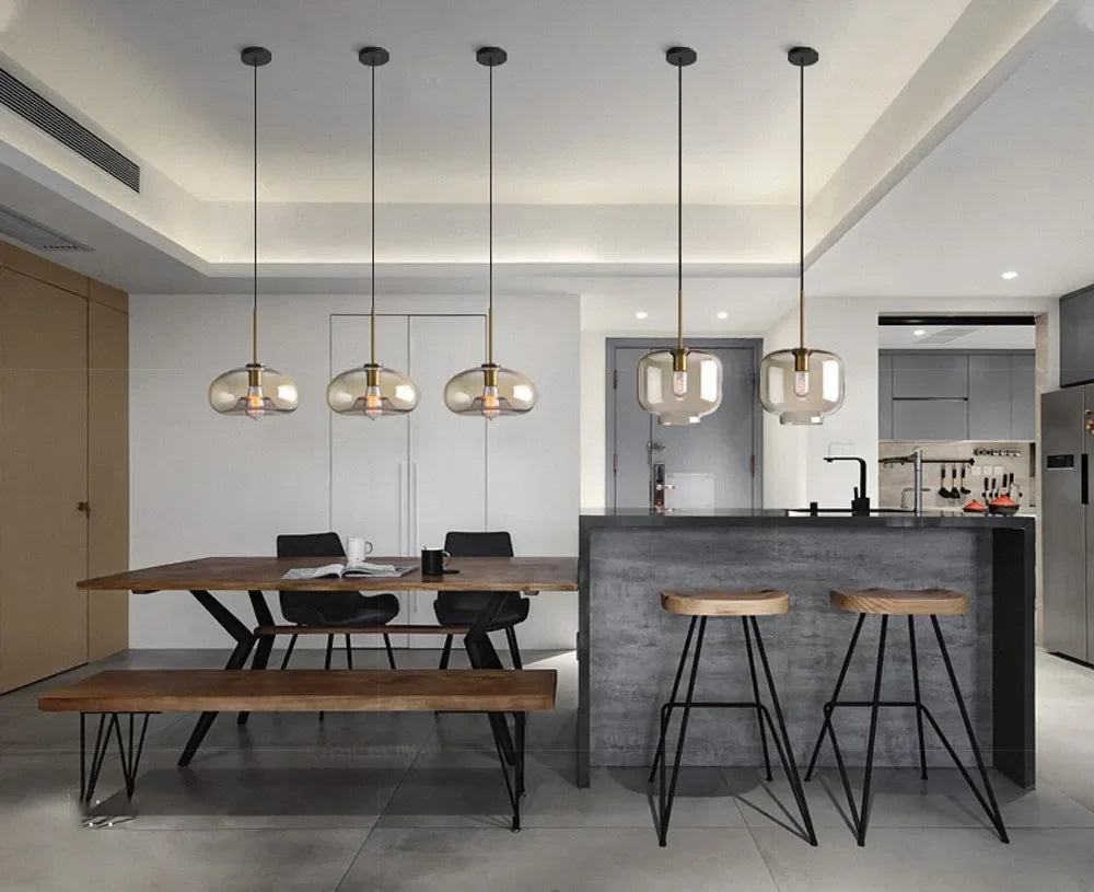 Five modern nordic led glass pendant lights with frosted glass shades and brass accents for dining room use
