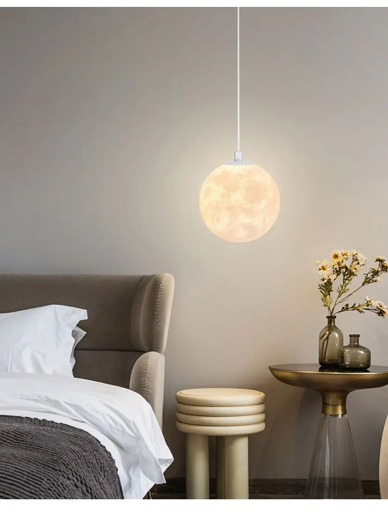 Nordic LED moon pendant chandelier with textured crater surface emits warm glow for dining room kitchen lighting