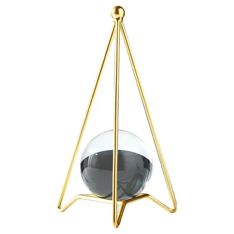 Nordic light luxury gold crystal ball crafts featuring a gold-toned triangular frame with a translucent gray and white sphere