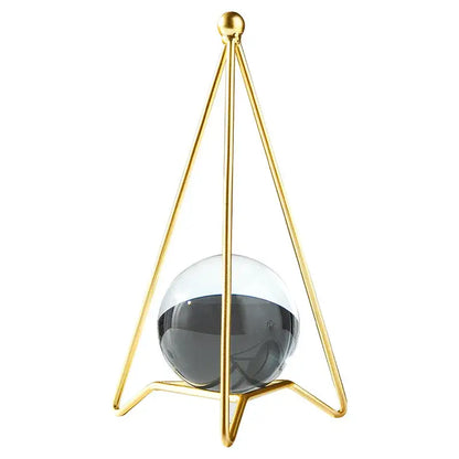 Nordic light luxury gold crystal ball crafts featuring a gold-toned triangular frame with a translucent gray and white sphere
