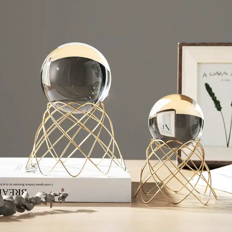 Two gold-toned wire mesh stands with reflective glass crystal balls and metallic tops for nordic light luxury decor
