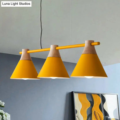 Vibrant yellow conical metal pendant lights with natural wood accents hanging from a sleek bar for kitchen island lighting