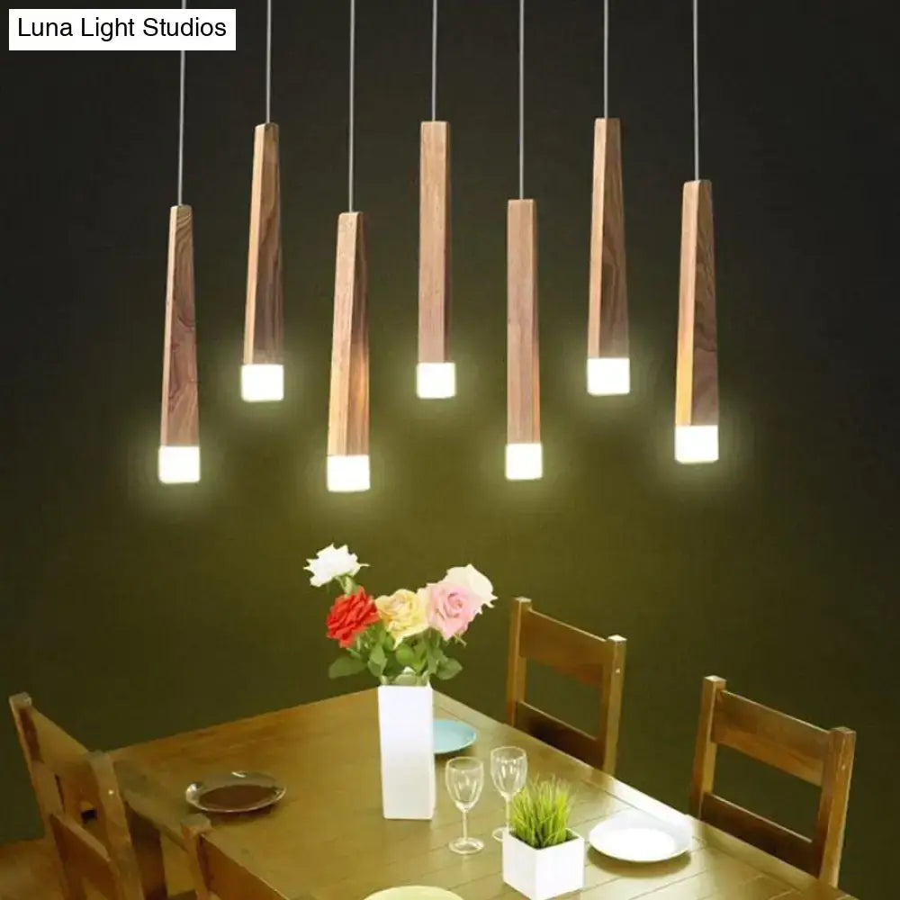 Five nordic minimalist wood pendant lamps with warm wooden bodies and glowing white led bases for dining room lighting