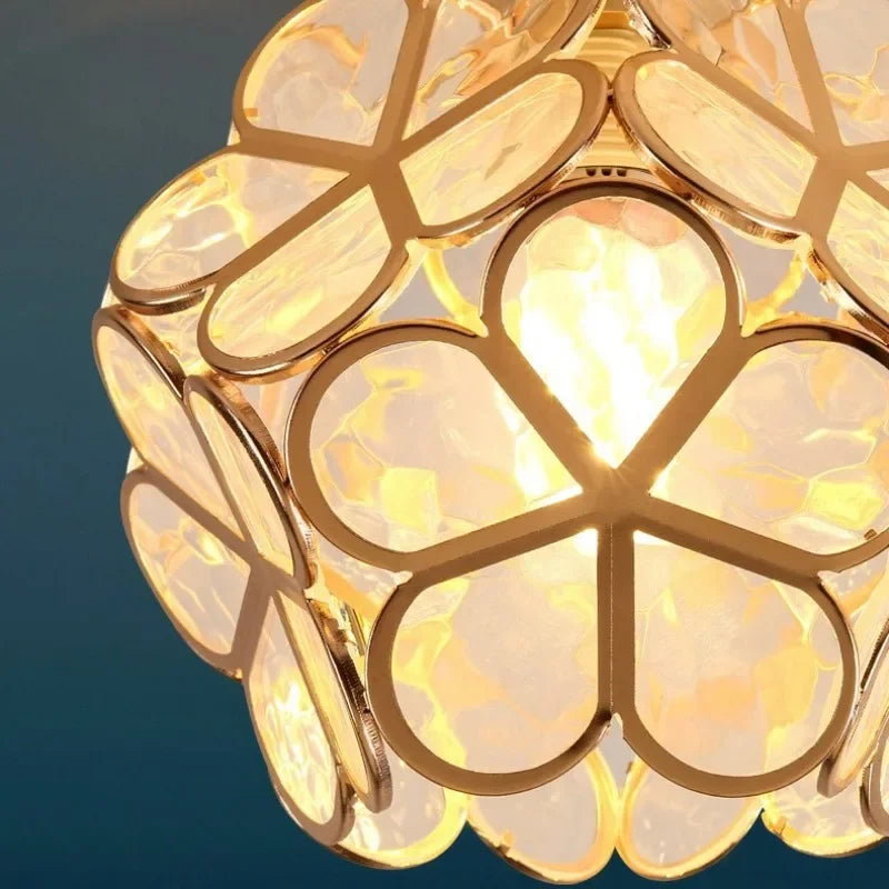 Golden floral Nordic modern petal acrylic pendant lamp with translucent textured glass petals and warm glowing interior