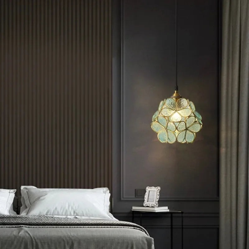 A delicate translucent green nordic modern petal acrylic pendant lamp with floral design hanging from the ceiling