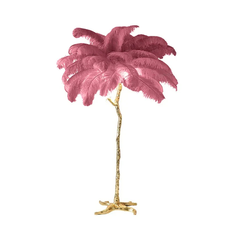 A tall golden metallic feather floor lamp with vibrant pink ostrich feathers for living room decor and lighting