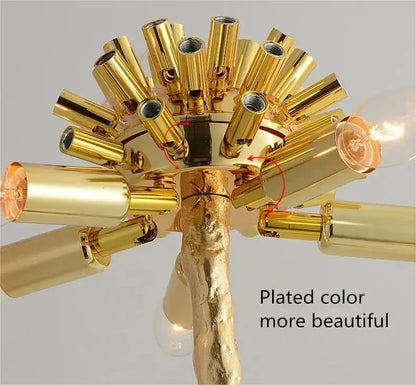 Golden-plated floor lamp with a textured branch-like stem and multiple cylindrical arms for living room decor