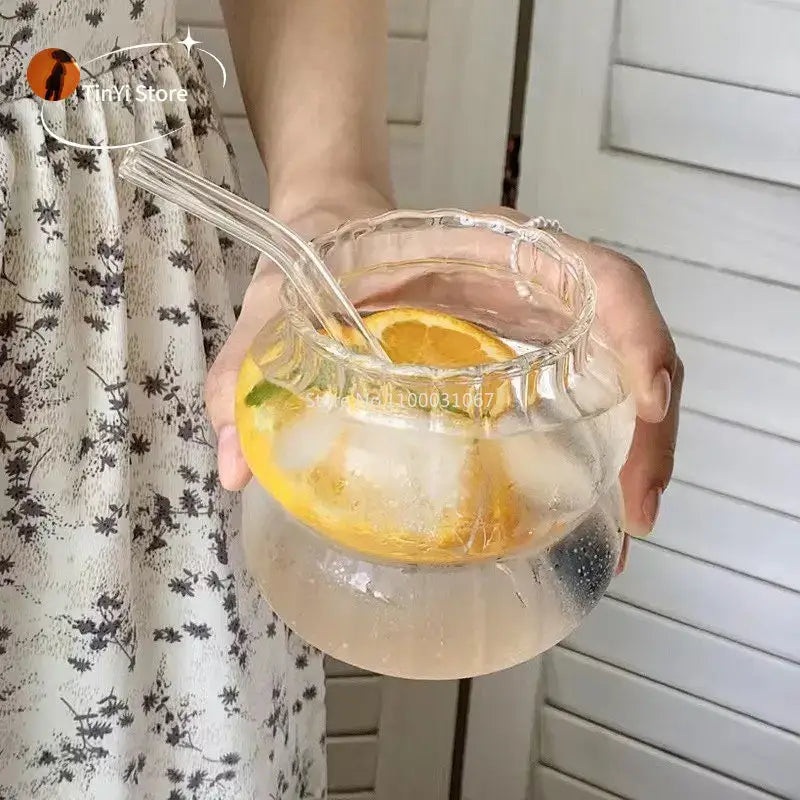 Clear glass pitcher with scalloped rim and handles filled with ice water and lemon slices for glass cocktail cups set decorbites