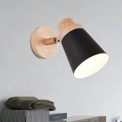 Nordic style wall light with a natural wood base and black matte coolie shade for baby room lighting
