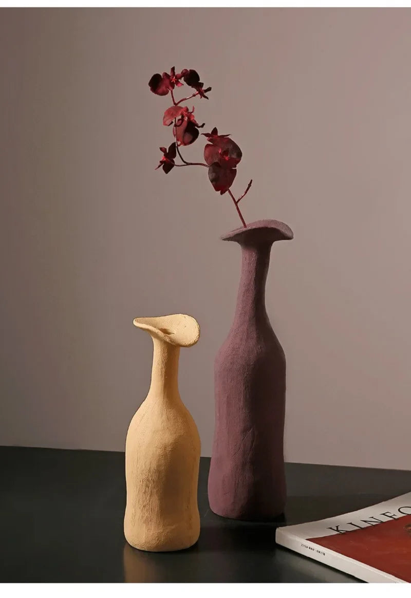 Two ceramic vases in soft beige and muted purple with textured surfaces and flared necks for modern Nordic decor