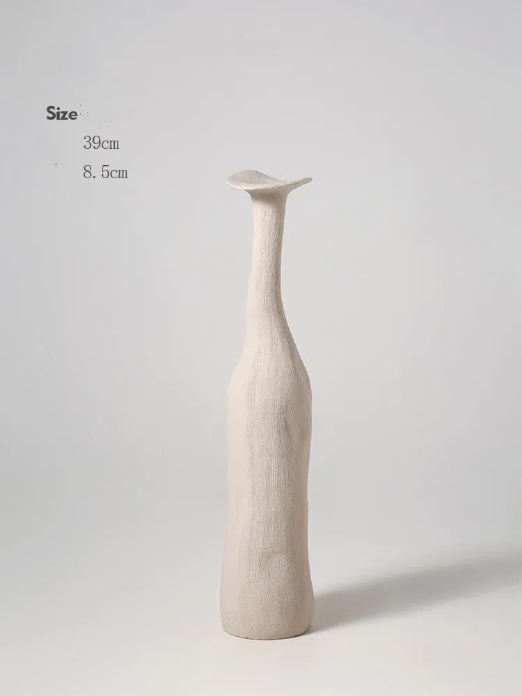 A tall slender off-white ceramic vase with a smooth textured surface and elongated neck for nordic style home decor