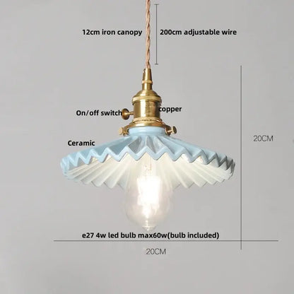 A delicate light blue ceramic pendant light with brass-finished switch and iron canopy for decorbites brown wood led decor