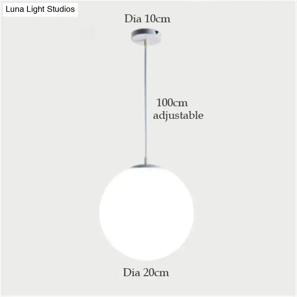 A decorbites™ nordic white glass ball pendant light with a 20cm diameter and adjustable 100cm chain for modern interiors