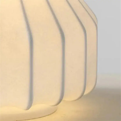 Cream-colored ribbed ceramic table lamp base with a matte finish for bedroom decorbites gatto silk lighting