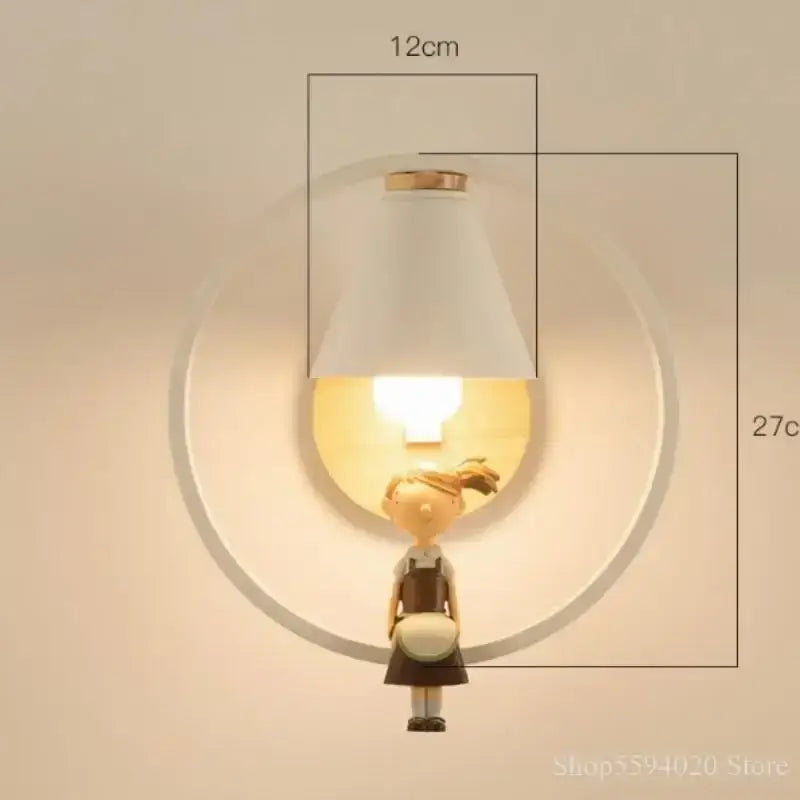 A white conical lampshade with gold rim mounted above a wooden figurine in the nordic birdie wall lamp