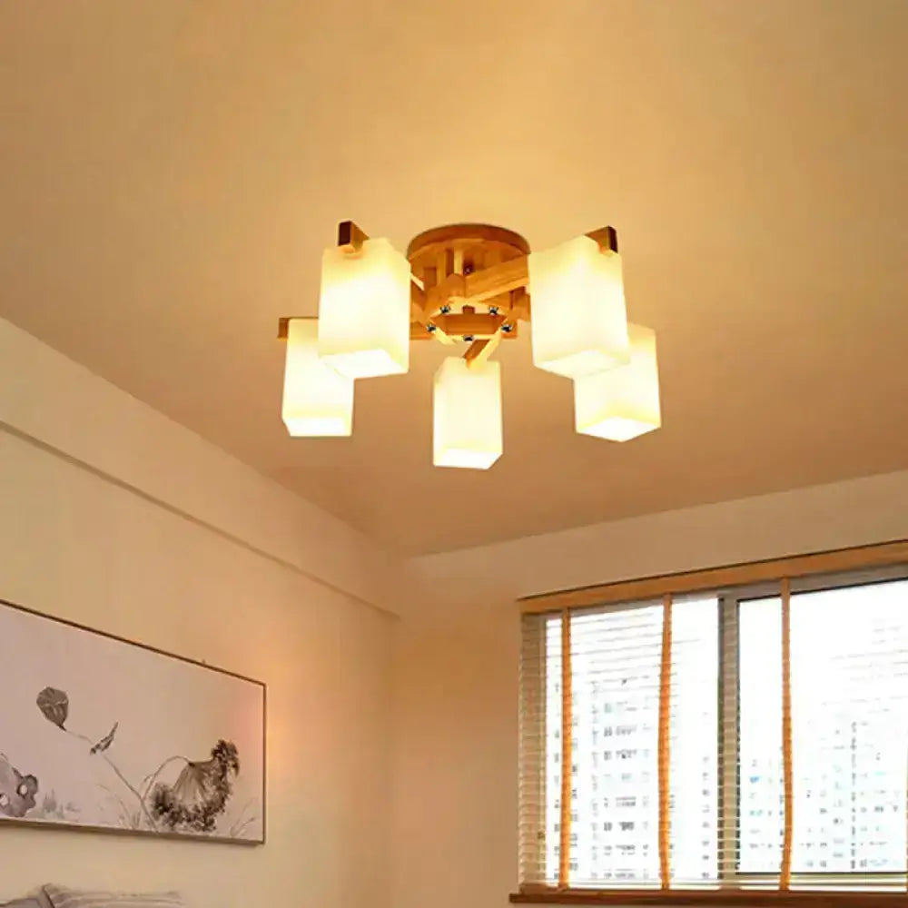 Nordic wood ceiling lamp with warm-toned finish and five cuboid cream glass shades for living room lighting
