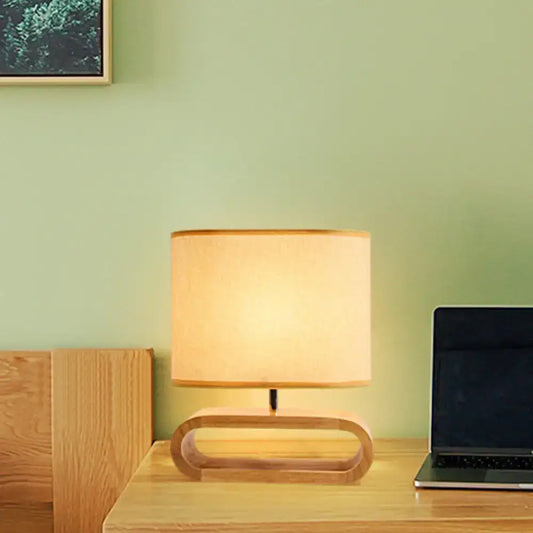 A warm-toned cylindrical lampshade on a minimalist wooden base nordic wood bedside table light 12 inch fixture