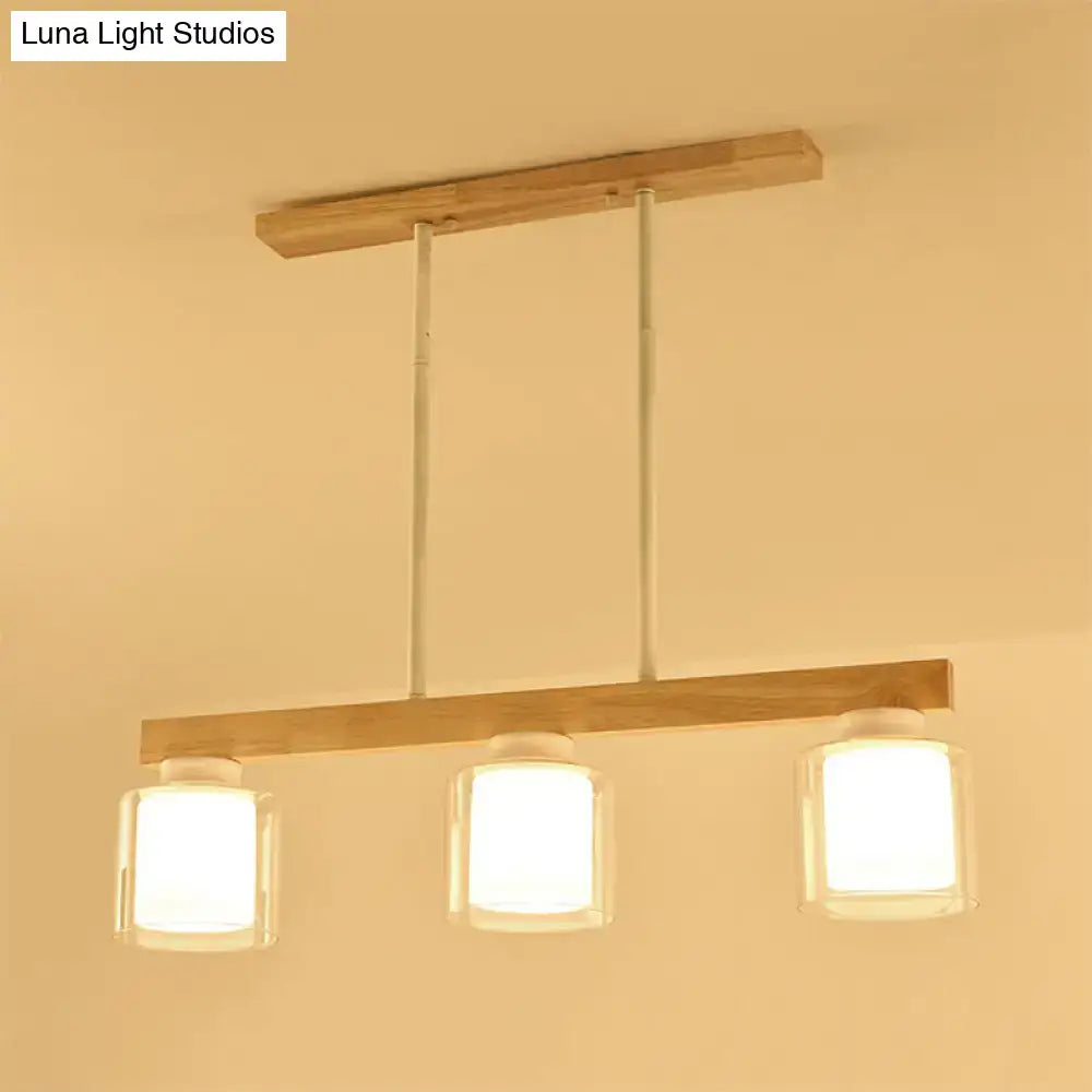 Minimalist DecorBites Nordic wooden linear pendant with three clear glass cylinder shades and white metal rods for island lighting