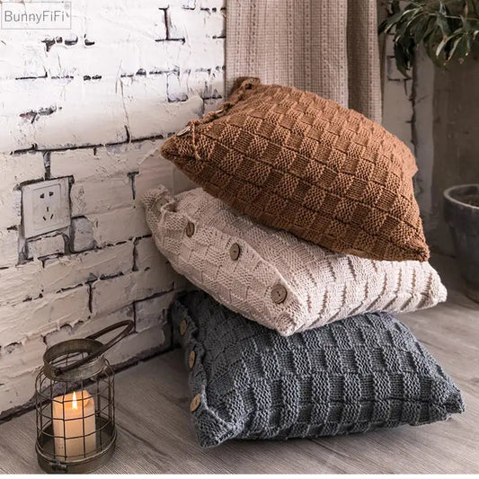 Stacked earthy tone decorbites knit pillow covers with woven texture and wooden button closure for living room decor