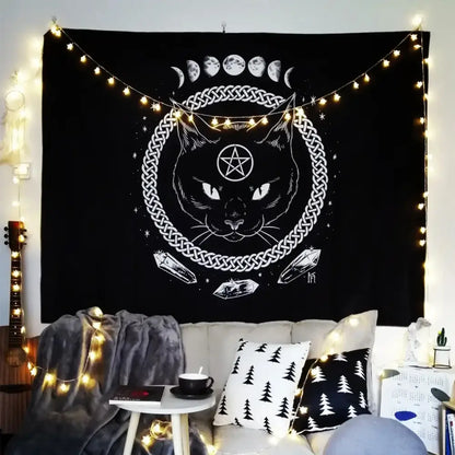 Black tapestry featuring white line-art cat coven face with pentagram, celtic knot and moon phases for mysterious decor