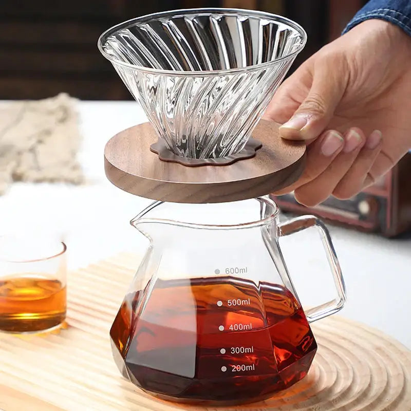 Clear glass coffee kettle octagonal pour-over dripper with fluted design on geometric glass carafe with volume marks