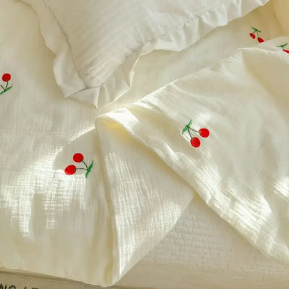 Off-white cotton summer quilt with delicate red cherry embroidery featuring double layer yarn design