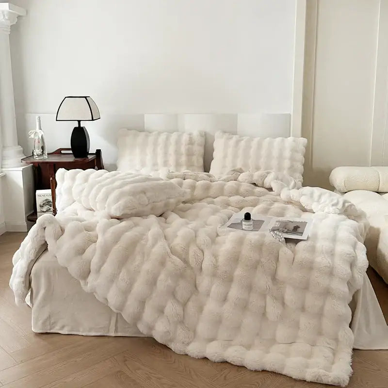 Cream-colored deluxe faux rabbit bedding set with plush textured quilt and rounded puffy design for bedroom decor